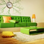 Svijetlo zelena sofa i narančasti naglasci u unutrašnjosti